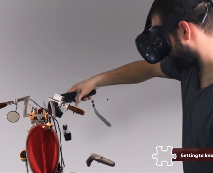 Ein bärtiger Mann mit einer VR Brille repariert ein Motorrad in einer VR Training Simulation..